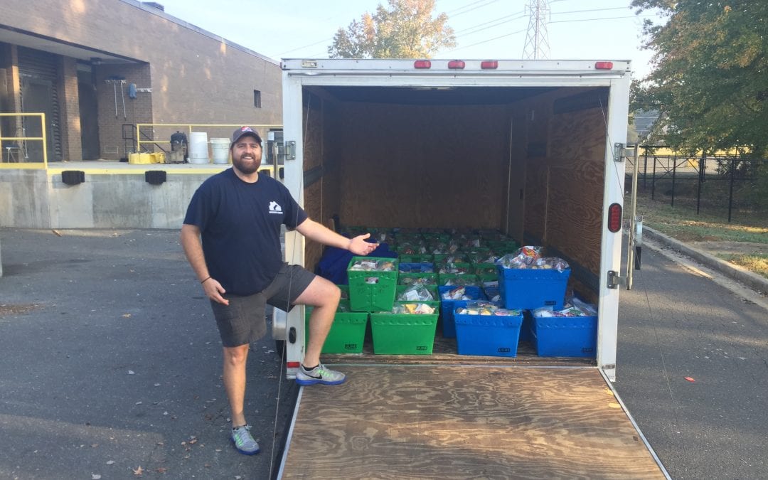 Man with recycling bins in moving truck